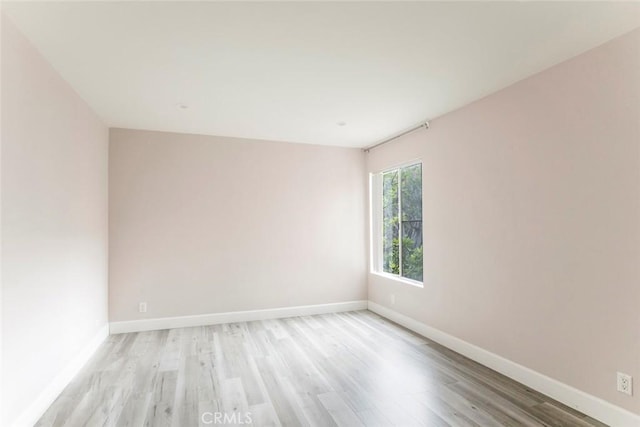 spare room with light wood-type flooring