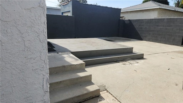 view of storm shelter with a patio