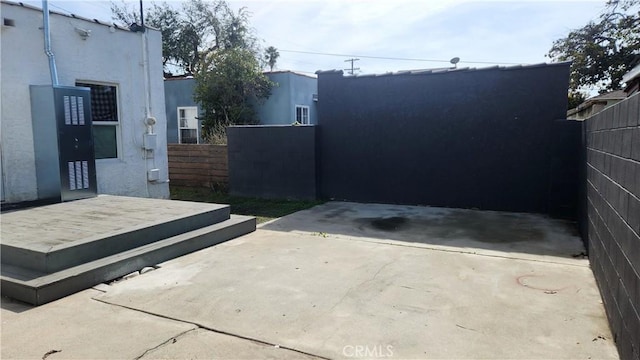 view of gate with a patio area and a wooden deck