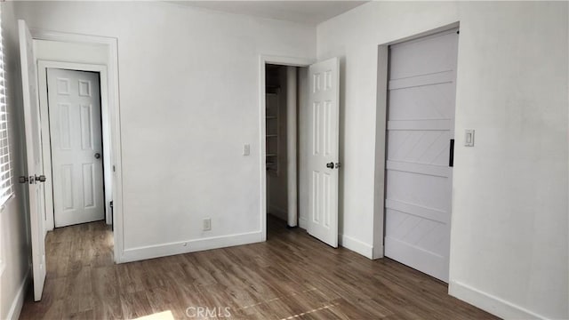 unfurnished bedroom featuring dark hardwood / wood-style flooring