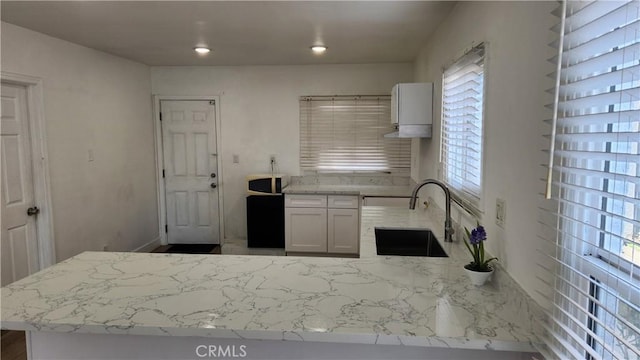 kitchen with sink and light stone counters