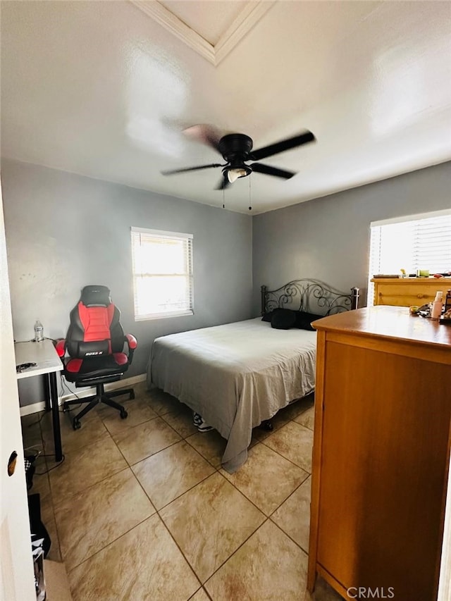 bedroom with ceiling fan and light tile patterned floors