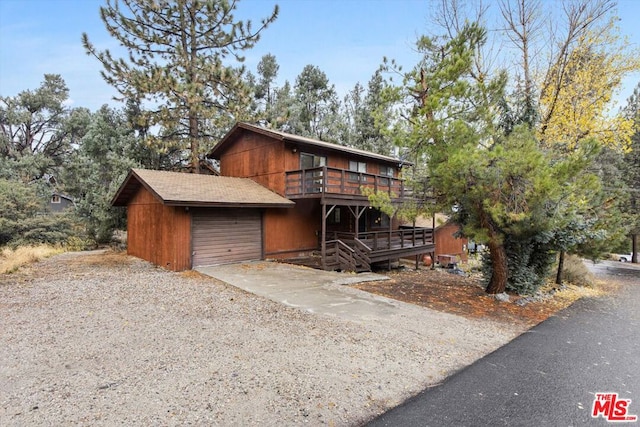 view of front facade with a garage and a deck