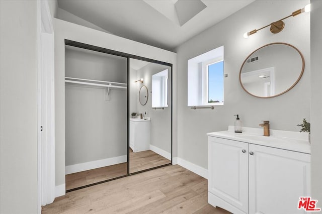 bathroom with hardwood / wood-style floors and vanity