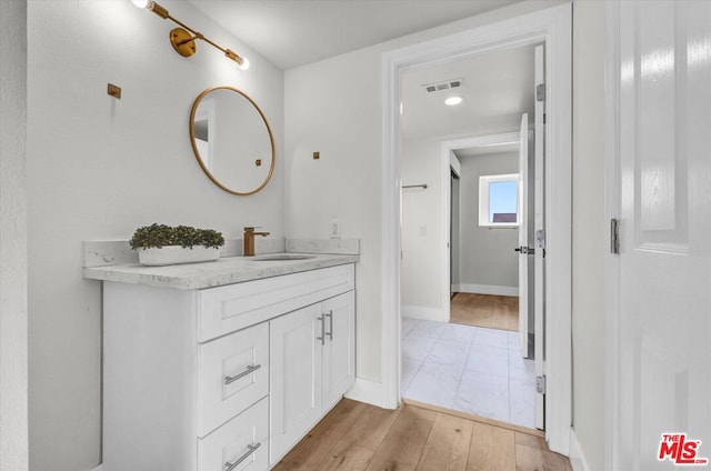 bathroom with hardwood / wood-style flooring and vanity