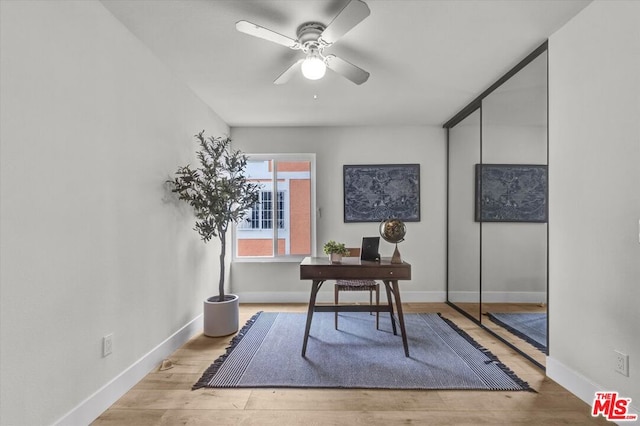 office space with light wood-type flooring and ceiling fan