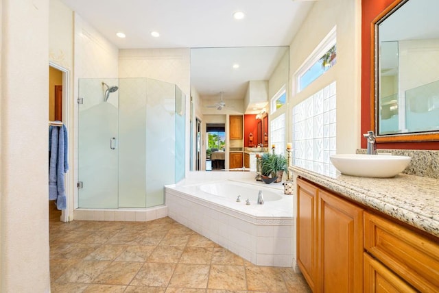 bathroom with vanity and independent shower and bath