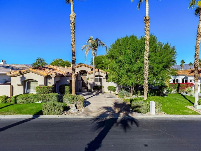 mediterranean / spanish-style home featuring a front yard