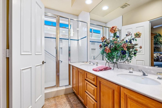 bathroom with tile patterned floors, vanity, and an enclosed shower