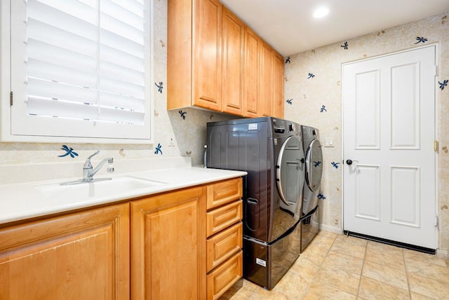 laundry room featuring washer and clothes dryer, cabinets, and sink