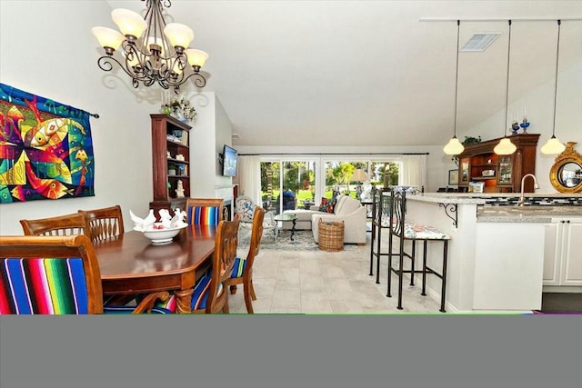 dining room featuring sink, vaulted ceiling, and a notable chandelier