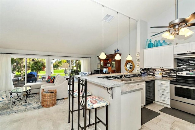 kitchen featuring stainless steel range, white cabinetry, and a breakfast bar