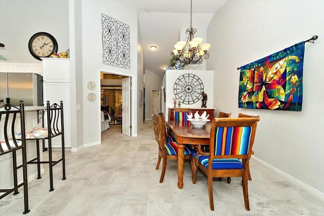 dining area with high vaulted ceiling and an inviting chandelier