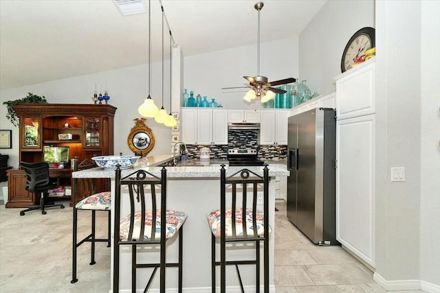 kitchen with lofted ceiling, kitchen peninsula, a breakfast bar, and appliances with stainless steel finishes