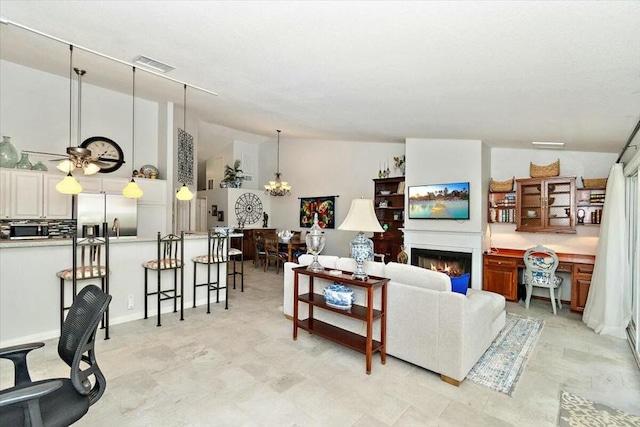 living room with vaulted ceiling and an inviting chandelier