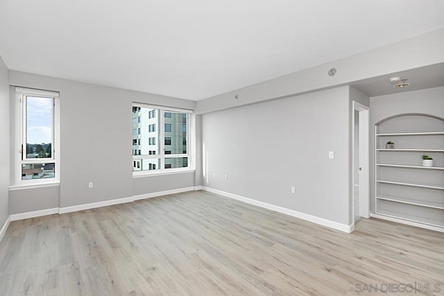 spare room with a healthy amount of sunlight and light hardwood / wood-style floors