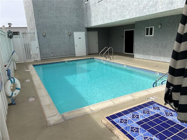 view of swimming pool featuring a patio area