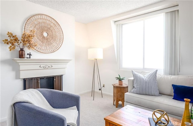 living area featuring light colored carpet, plenty of natural light, and a textured ceiling