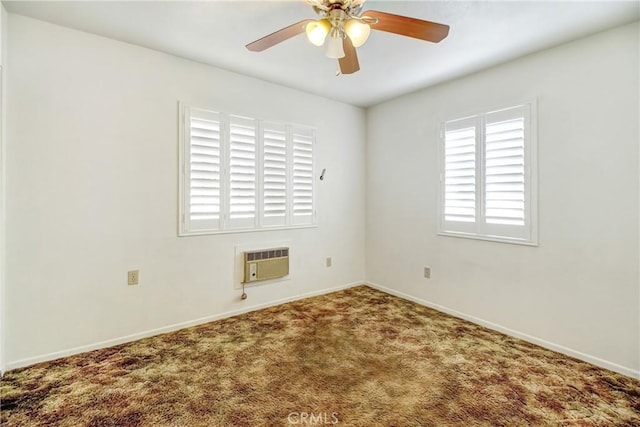 spare room with carpet floors, a wall mounted AC, and ceiling fan