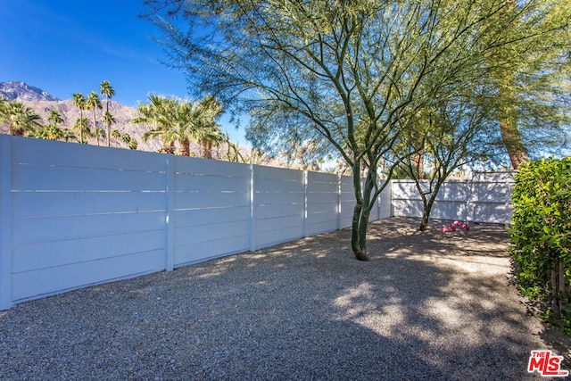 view of gate with a mountain view