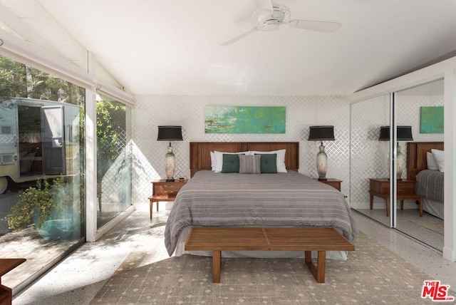 bedroom with ceiling fan, a closet, and lofted ceiling