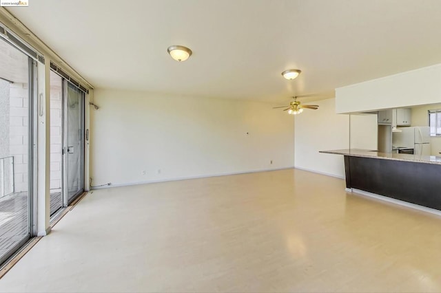 unfurnished living room with ceiling fan