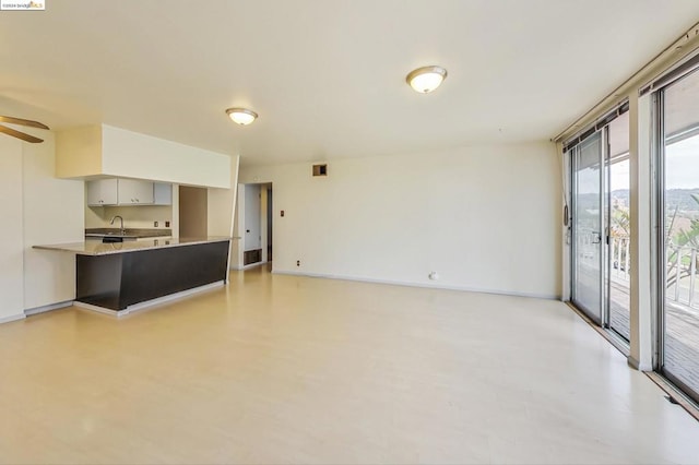 living room with ceiling fan and sink