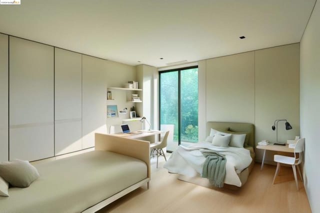 bedroom featuring expansive windows and light wood-type flooring