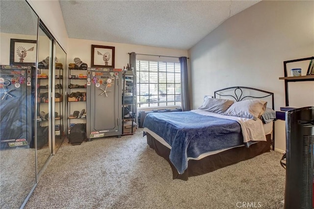 bedroom with a textured ceiling, carpet floors, and lofted ceiling