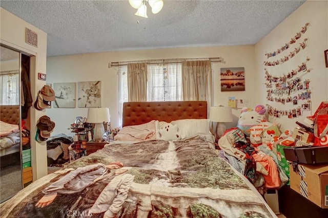 11350 Foothill Blvd Unit 30, Sylmar, CA 91342 - bedroom featuring a textured ceiling, multiple windows, a ceiling fan, and a closet