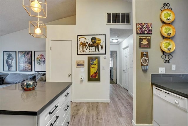 11350 Foothill Blvd Unit 30, Sylmar, CA 91342 - kitchen with white dishwasher, lofted ceiling, dark countertops, white cabinets, and light wood finished floors