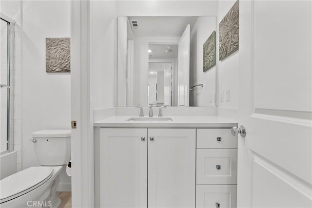 full bathroom featuring vanity, toilet, and enclosed tub / shower combo