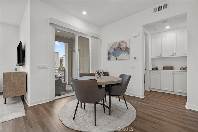 dining area featuring dark wood-type flooring