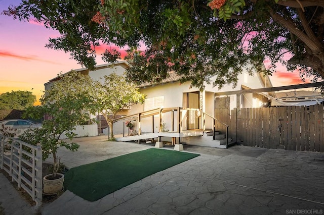 back house at dusk with a patio