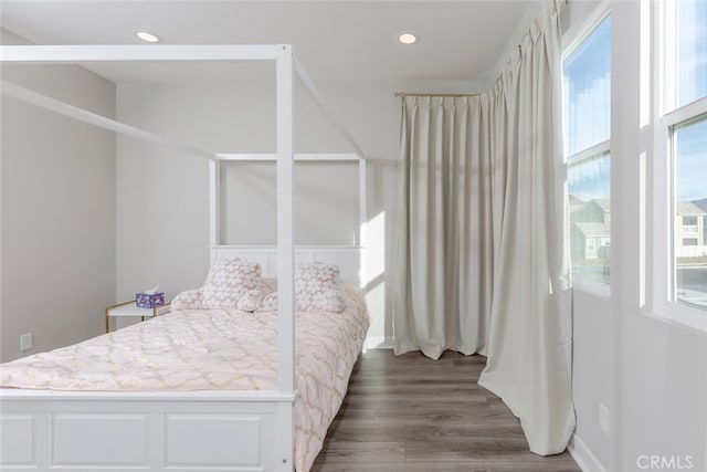 bedroom with dark hardwood / wood-style flooring