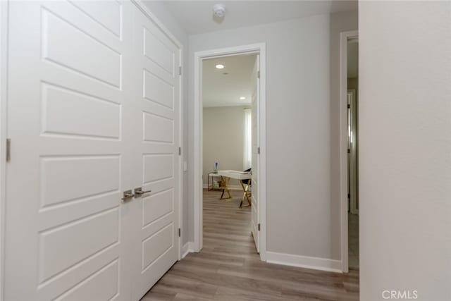 corridor with light wood-type flooring