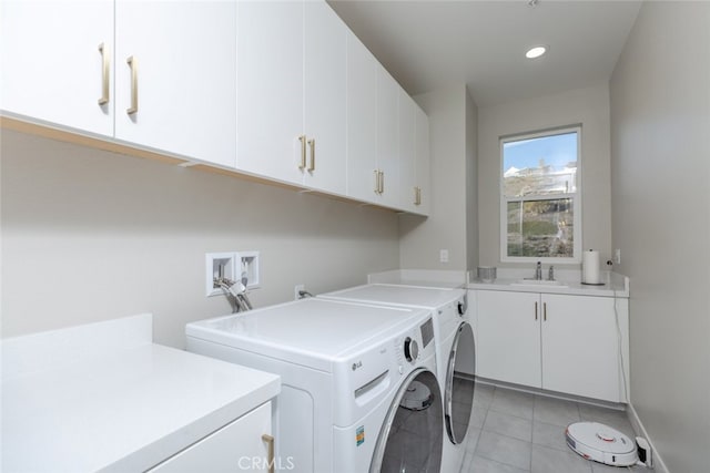 laundry room with cabinets, independent washer and dryer, sink, and light tile patterned floors