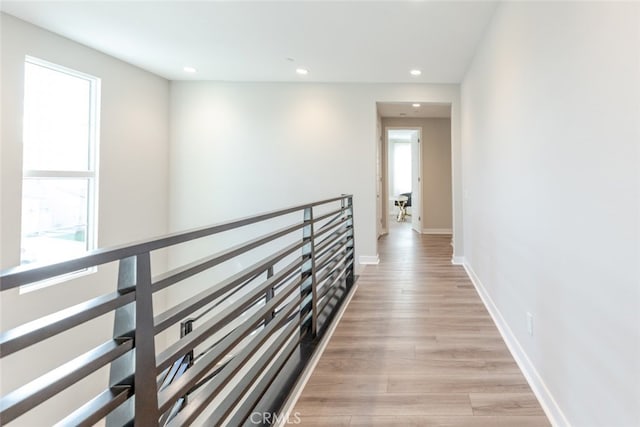 corridor with light hardwood / wood-style floors