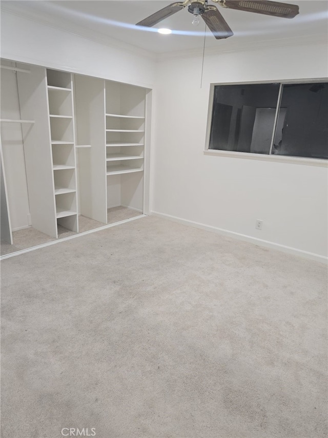 unfurnished bedroom with ceiling fan and carpet