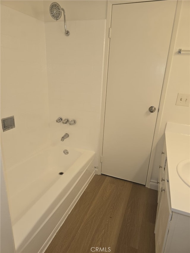 bathroom featuring tub / shower combination, hardwood / wood-style flooring, and vanity