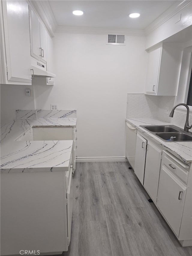 kitchen with white cabinetry, light hardwood / wood-style floors, white dishwasher, ornamental molding, and sink