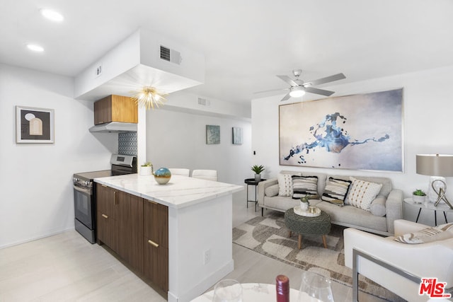 kitchen featuring stainless steel electric range oven, dark brown cabinets, and ceiling fan