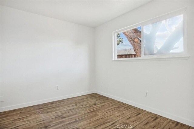 spare room with hardwood / wood-style floors