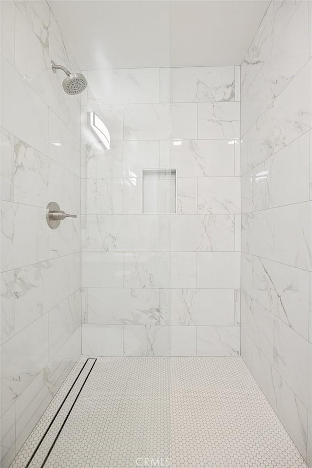 bathroom with a tile shower