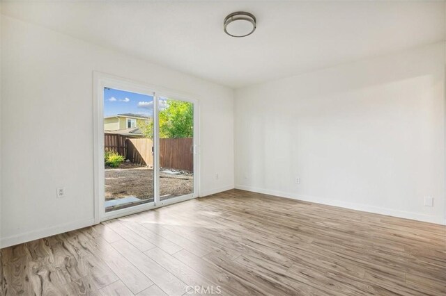 spare room with light wood-type flooring