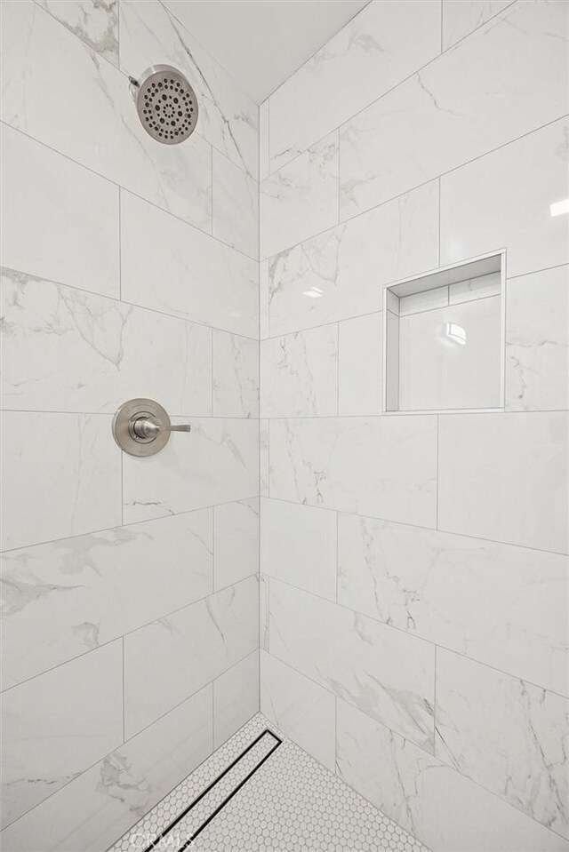 bathroom with a tile shower