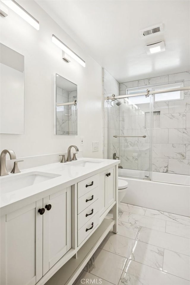 full bathroom featuring bath / shower combo with glass door, toilet, and vanity