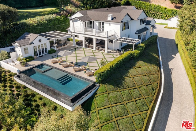 back of house with a balcony and a patio