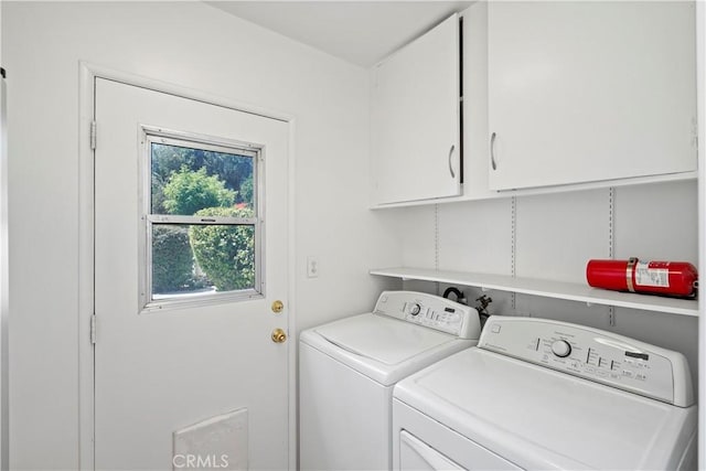 washroom with cabinets and separate washer and dryer