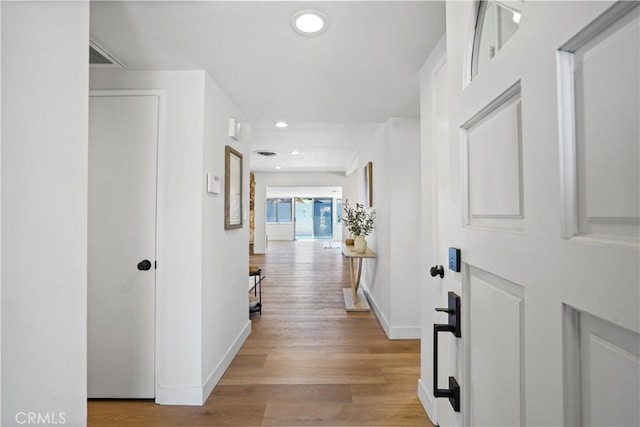 hall with light wood-type flooring